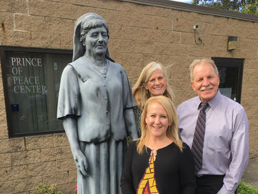 Lisa Louis, Catholic Foundation executive director, with Prince of Peace Center's executive director Joseph Flecher and board member Lisa Dach