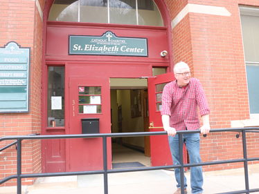 Director Douglas Kennedy in front of the St. Elizabeth Center