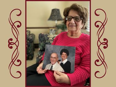 Janet Mehall holding a photo of herself and her husband, Frank