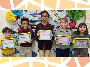 Students from Saint John Paul II Elementary School, Hermitage, PA, show off their iPads with a message for the Catholic Foundation.