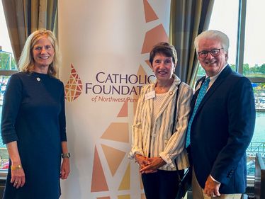 Lisa Louis, Executive Director of the Catholic Foundation with Jane and Mike Zavasky