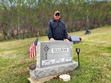 Paul Sullivan at his parents' grave in Saint Raphael Cemetery