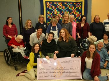 Lisa Louis presents the 2019 grant distribution to L'Arche Erie