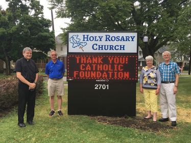 Fr. John Jacquel, Joe Mattis, and Pat & Richard Marshall appreciate the grant from the Foundation that helped them purchase a new sign for their church.