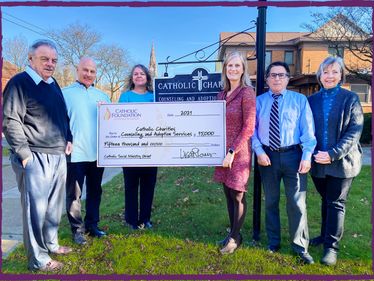 Lisa Louis, Foundation Executive Director (3rd from right), with (l to r) Don Carone, Deacon Richard Brogdon, Kirsten Etnoyer, David DiLoreto, and Michele Knauer of Catholic Charities Counseling & Adoption Services