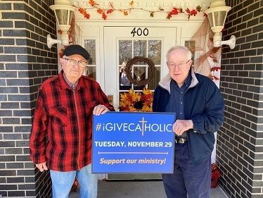 Father Leo Gallina (left) and Monsignor Robert Smith (right) holding their #iGiveCatholic sign outside of the Bishop Michael J. Murphy Residence for Retired Priests
