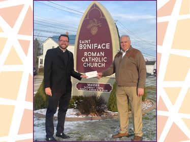 Ken Kane (Foundation board secretary) presents a grant check to Father Kevin Holland, Pastor of Saint Boniface Parish