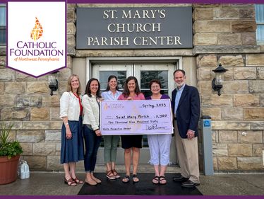 Lisa Louis (Executive Director, left) and Vince Assetta (Foundation board member, far right) present grant check to Saint Mary Parish staff members Samantha Nedzinski, Bonnie Pearson, Mary Lynn Carnovale, & Ann Marie Pfoutz.